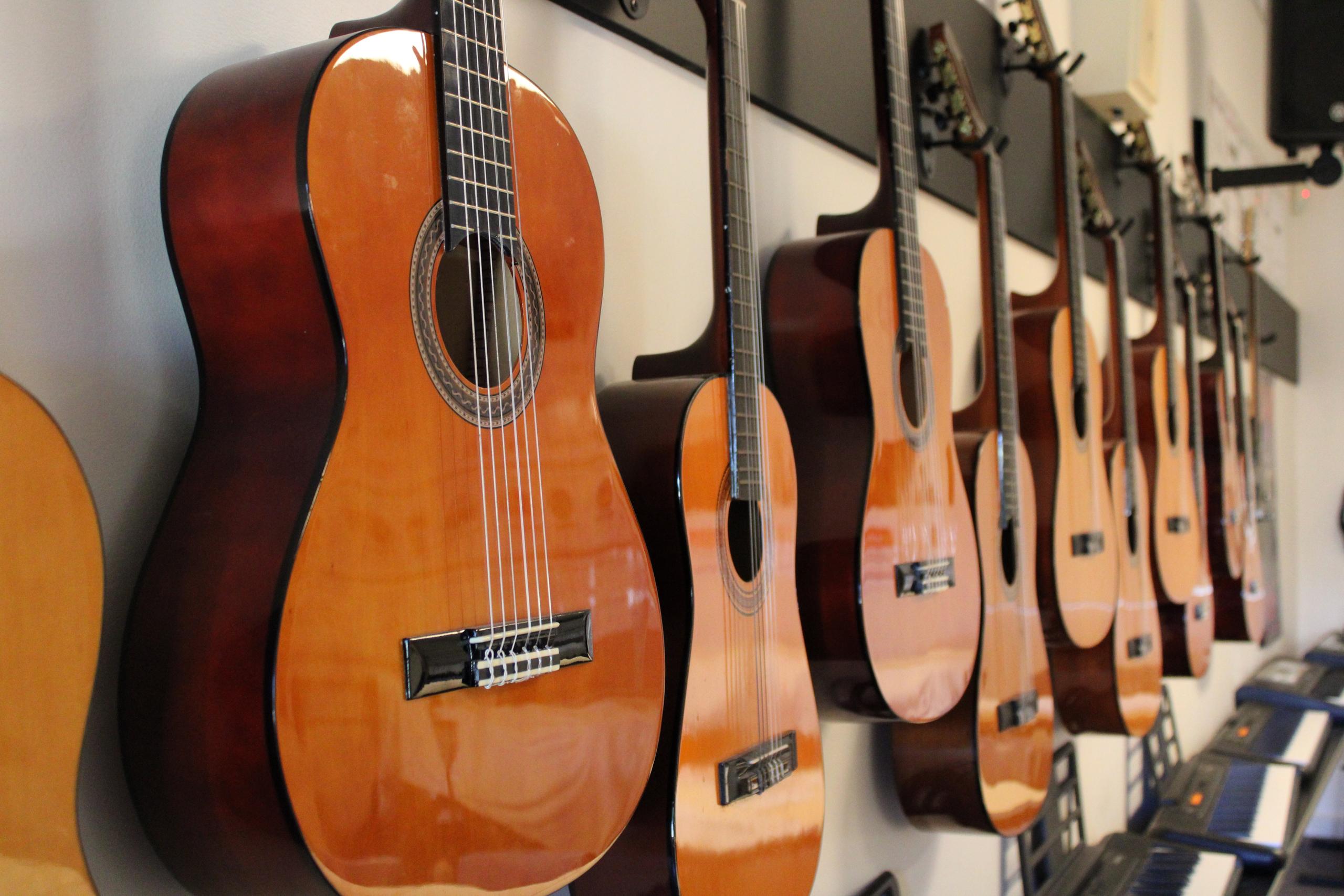 Acoustic guitars hanging on the wall within the music room.