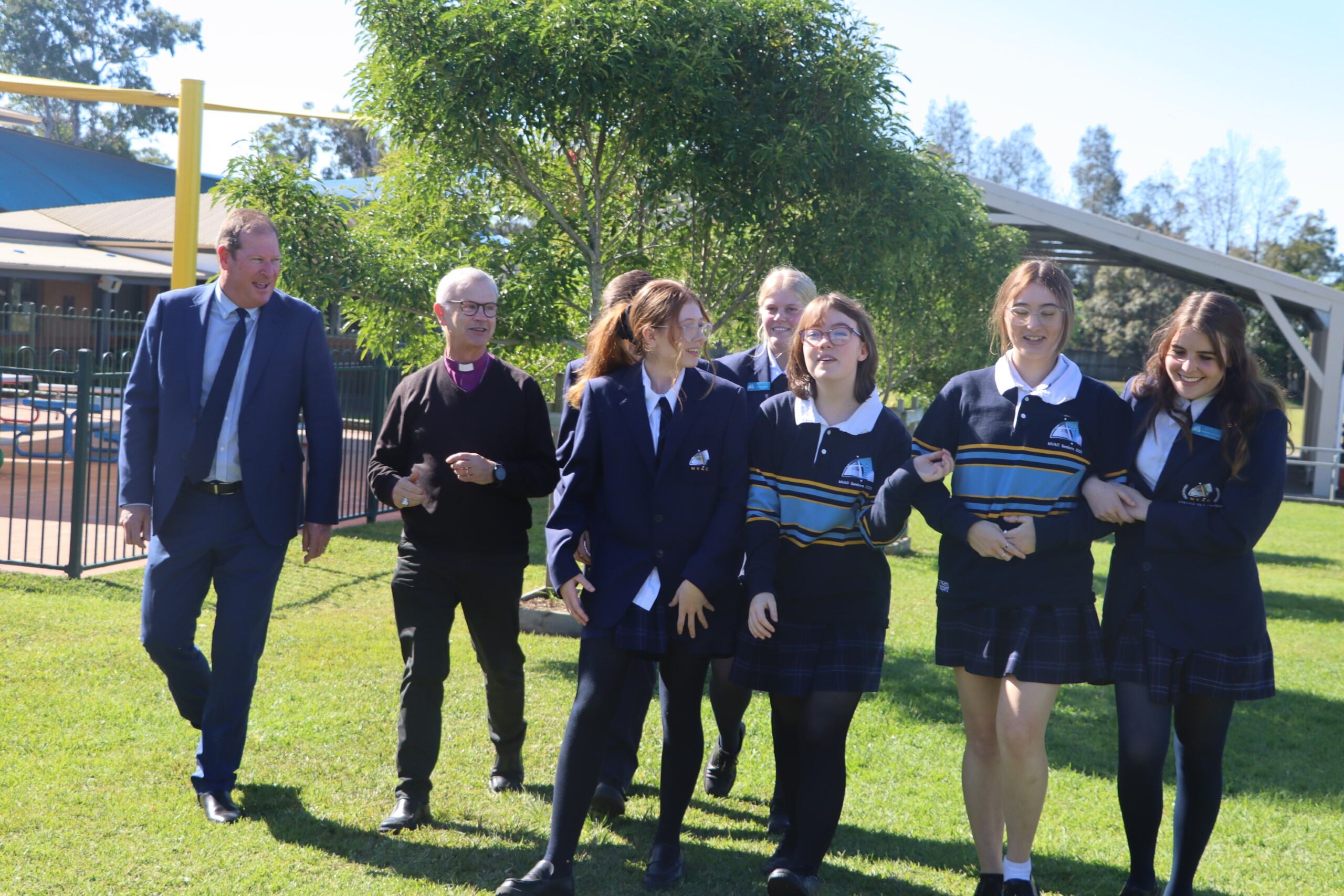 Principal Darren Parks, Bishop Peter and former Year 12 leaders walking and talking through the College Grounds.